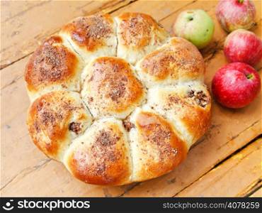 above view of baked closed apple pie and fruits on wooden board