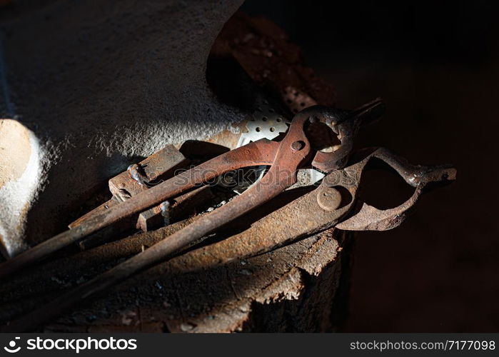 Above view of blacksmiths tongs in workshop.. Above view of blacksmiths tongs in workshop