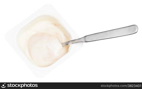 above view of creamy yogurt and spoon in disposable plastic cup isolated on white background