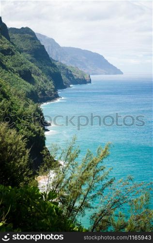 Abrupt mountains and shores seen from a view point in the Kalalau Trail in Kauai, Hawaii, US. Scenic view point in the Kalalau Trail in Kauai, Hawaii, US