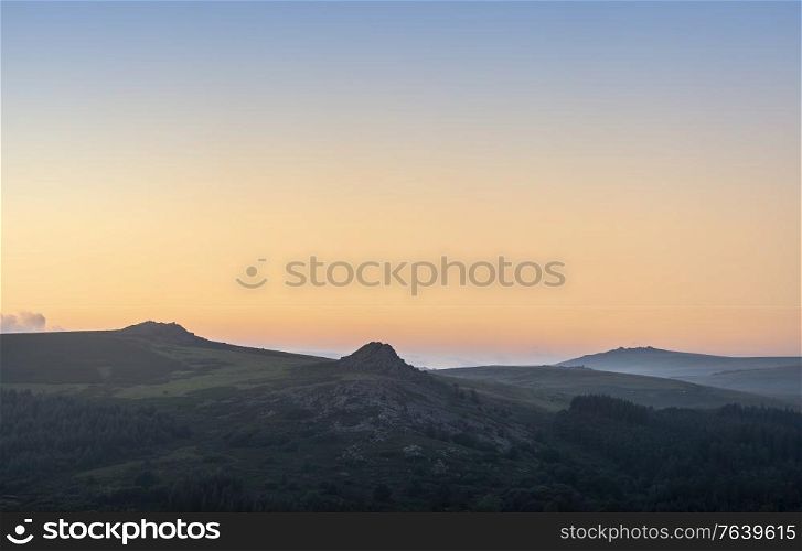 Absolutely stunning landscape image of Dartmoor in England showing Leather Tor, Sharpitor and Kings Tor in epic sunrise light