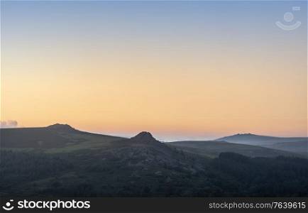 Absolutely stunning landscape image of Dartmoor in England showing Leather Tor, Sharpitor and Kings Tor in epic sunrise light