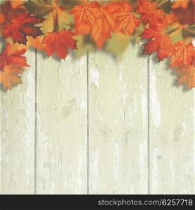 Abstract autumnal backgrounds with maple leaves over old wooden desk