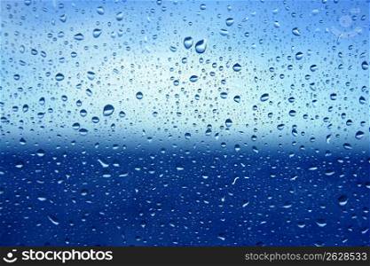 Abstract backdrop blue water drops on a boat glass window background