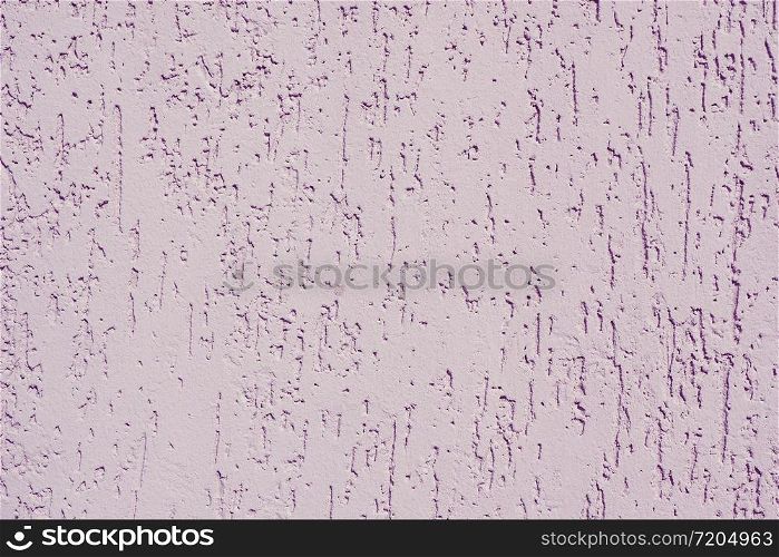 Abstract background and texture of a lilac plastered wall with bark beetle texture.