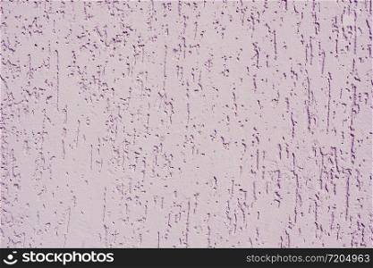 Abstract background and texture of a lilac plastered wall with bark beetle texture.