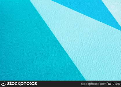 Abstract background and texture of several sheets of blue paper in different shades.