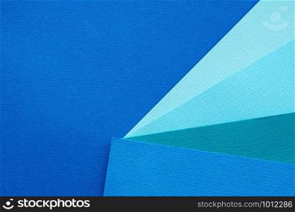 Abstract background and texture of several sheets of blue paper in different shades.