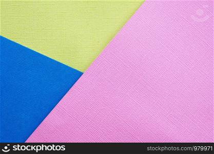 Abstract background and texture. Three multi-colored sheets of texture paper pink, yellow and blue.