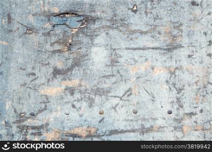 abstract background consisting of weathered board with old blue paint and bolts