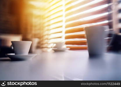 Abstract background duo tone coffee cups on the table lines defocused blurred