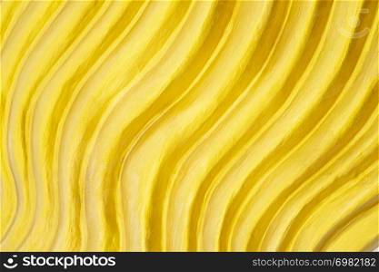 Abstract background from gold curve decorated on wall. Yellow backdrop.