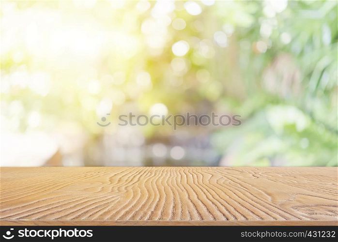 Abstract background from wooden table top with blurred nature with backlight.