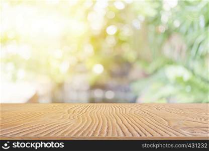 Abstract background from wooden table top with blurred nature with backlight.