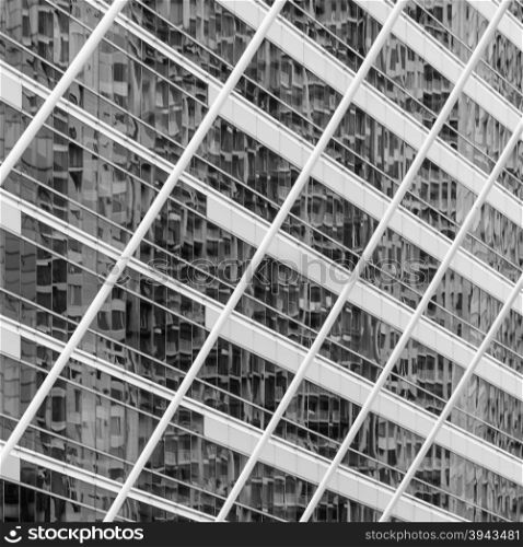 Abstract background image of blur exterior building with reflection on glass window. Black and white image