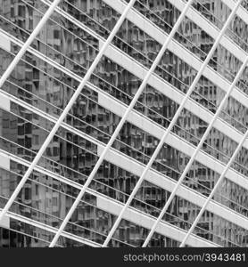 Abstract background image of blur exterior building with reflection on glass window. Black and white image