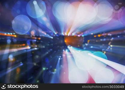 Abstract background image of circular bokeh motion blurred stree. Abstract background image of circular bokeh motion blurred street light background of city, traffic light from car on street at night time. Zoom effect.