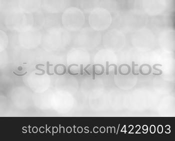 Abstract background of a blurry black and white lights.