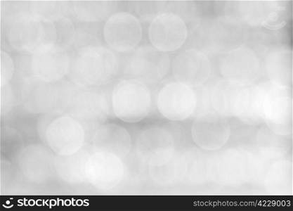 Abstract background of a blurry black and white lights.