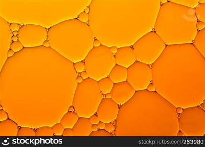 Abstract background of orange oil drops on water surface. Abstract background of orange oil drops on water