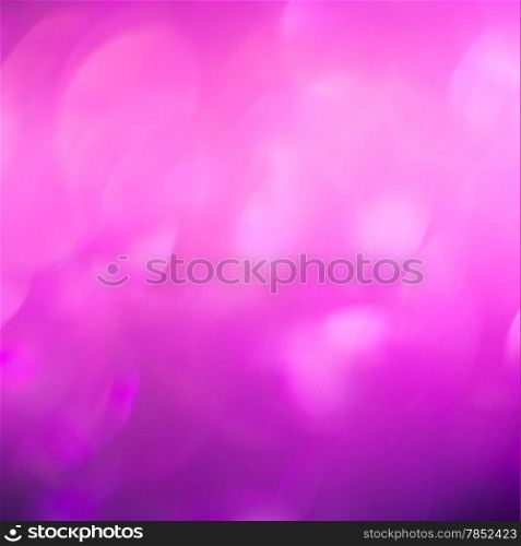 Abstract background of pink holiday lights with copy space.