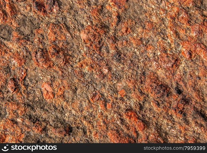 Abstract background of red granite with a rough surface
