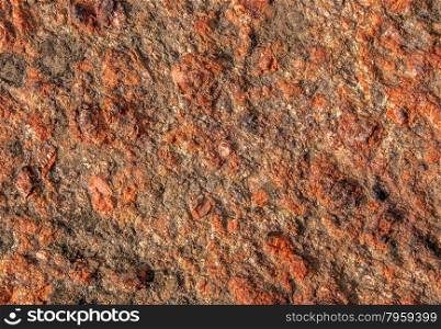 Abstract background of red granite with a rough surface