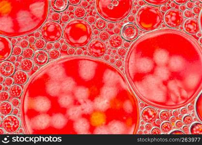 Abstract background of red oil drops on water surface. Abstract background of red oil drops on water