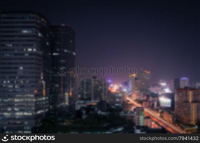 Abstract background of the night light trails on the modern building and traffic, shallow depth of focus