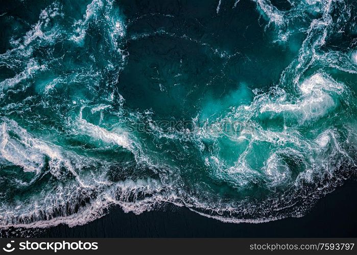 Abstract background. Waves of water of the river and the sea meet each other during high tide and low tide. Whirlpools of the maelstrom of Saltstraumen, Nordland, Norway