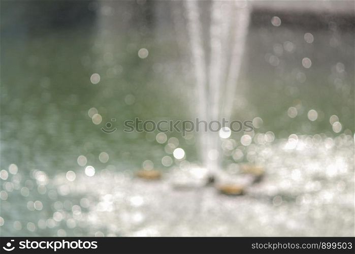 Abstract background white and grey bokeh lights of fountain .
