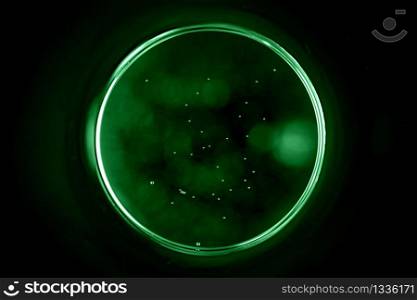 Abstract background with a black hole in green. Sphere on black background.