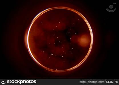 Abstract background with a black hole in red. Sphere on black background.