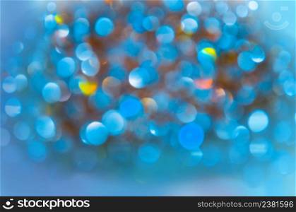 Abstract background with blue bokeh lights. Defocused blue lights background . Festive Christmas elegant abstract background.