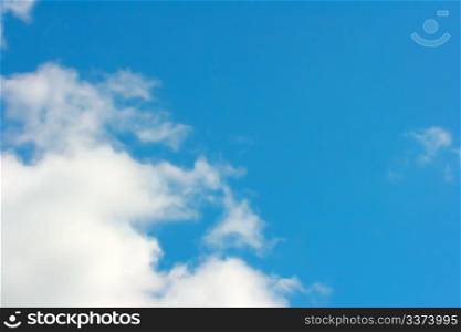 Abstract background with white clouds and blue sky.