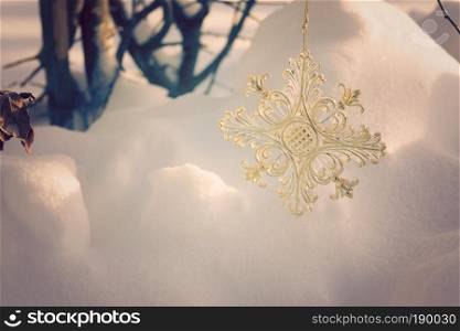Abstract background with yellow sparkling snowflake made of plastic.