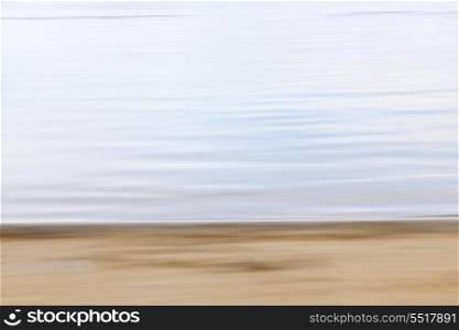 Abstract beach blur. Background image of sand and water created by horizontal in-camera motion blur