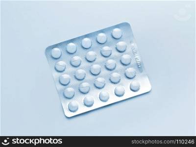 Abstract blue medical background with pills packed in blister
