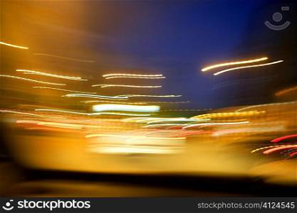abstract blur city golden night lights, blue sky and traffic