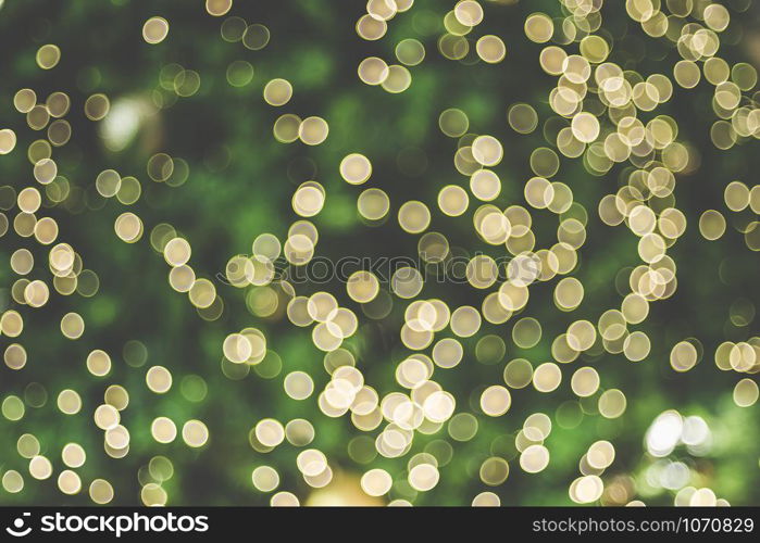 Abstract blur decoration ball and light string on christmas tree with bokeh light background.winter holiday seasonal