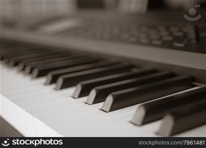 abstract blur of Piano Keyboard synthesizer closeup key frontal view, vintage theme