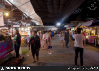 abstract blur people walking food stall at night market festival for background usage.