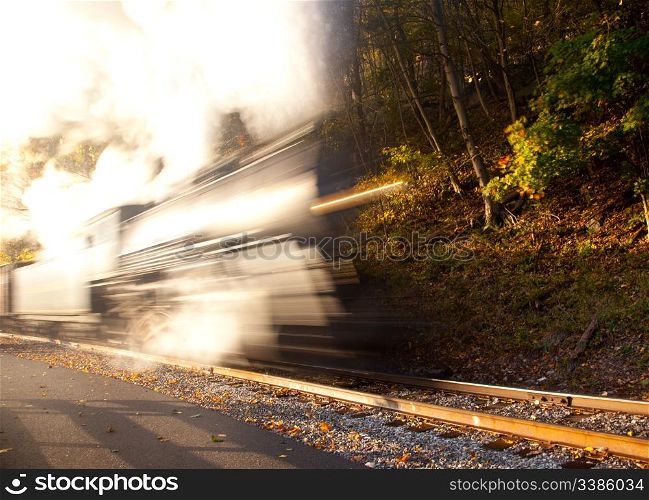 Abstract blur view of a steam train powering up a rural line in fall