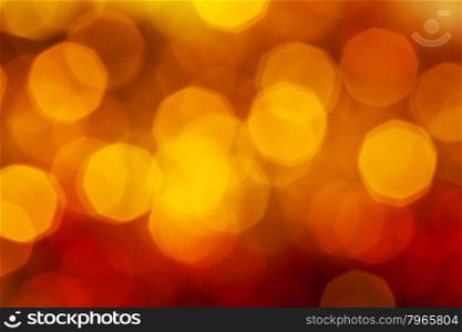 abstract blurred background - big dark red, yellow, brown shimmering Xmas lights bokeh of garlands on Christmas tree