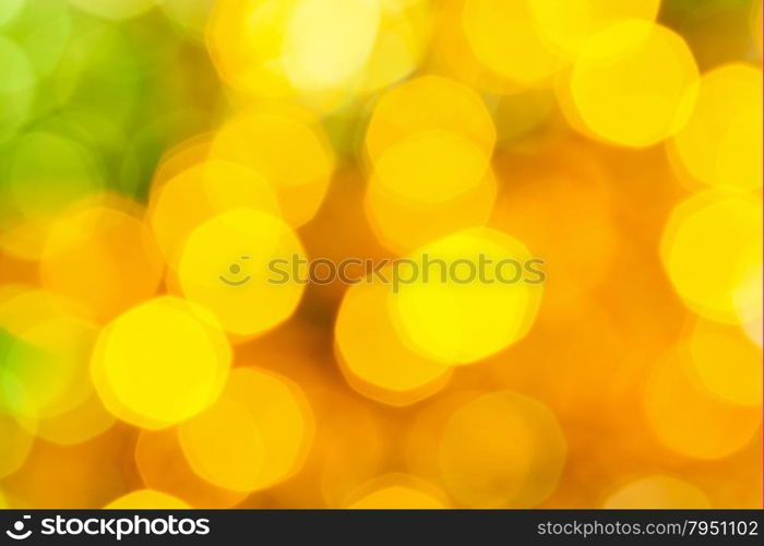 abstract blurred background - big yellow and green shimmering Christmas lights of electric garlands on Xmas tree