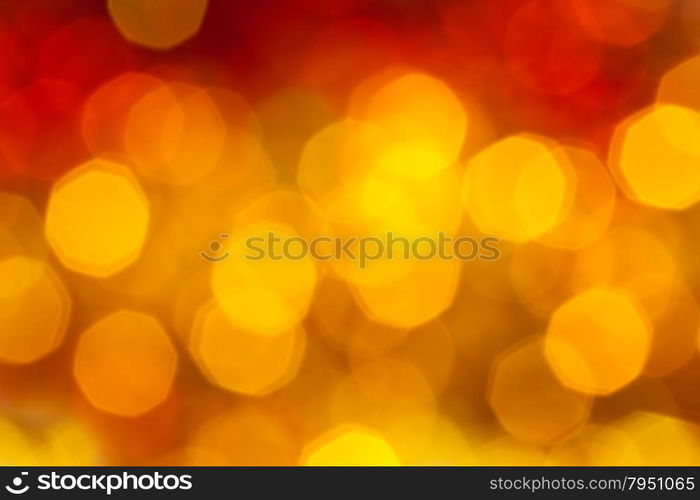 abstract blurred background - big yellow and red flickering Xmas lights of garlands on Christmas tree