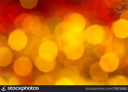 abstract blurred background - big yellow and red flickering Xmas lights of garlands on Christmas tree