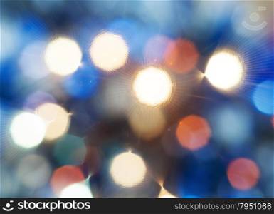 abstract blurred background - blue shimmering Christmas lights from diffise filter of electric garlands on Xmas tree