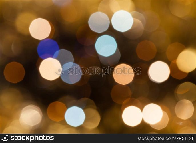abstract blurred background - brown and pink shimmering Christmas lights of electric garlands on Xmas tree