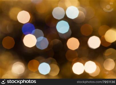 abstract blurred background - brown and pink shimmering Christmas lights of electric garlands on Xmas tree
